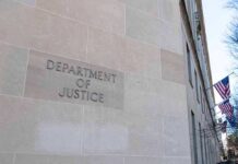 Department of Justice building exterior with American flags