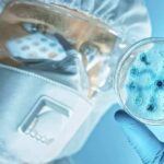 Plague Lab Death Sparks Global Watch Scientist in protective gear examining a petri dish