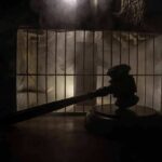 Execution Fails – Panic In Death Row Judge’s gavel in silhouette before prison bars