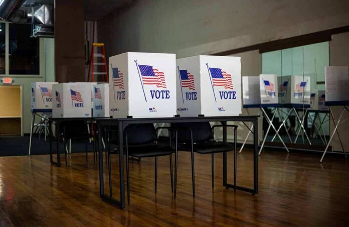 Voting booths with American flags in an empty polling place