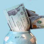 Trump-Branded Checks Hit Swing States Bill jar with U.S. Treasury check and cash sticking out