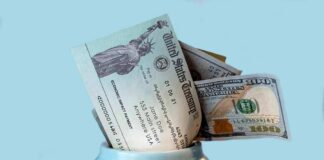 Bill jar with U.S. Treasury check and cash sticking out