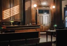 Bottle Attack Caught – No Jail? Empty courtroom with wooden benches and judge's bench
