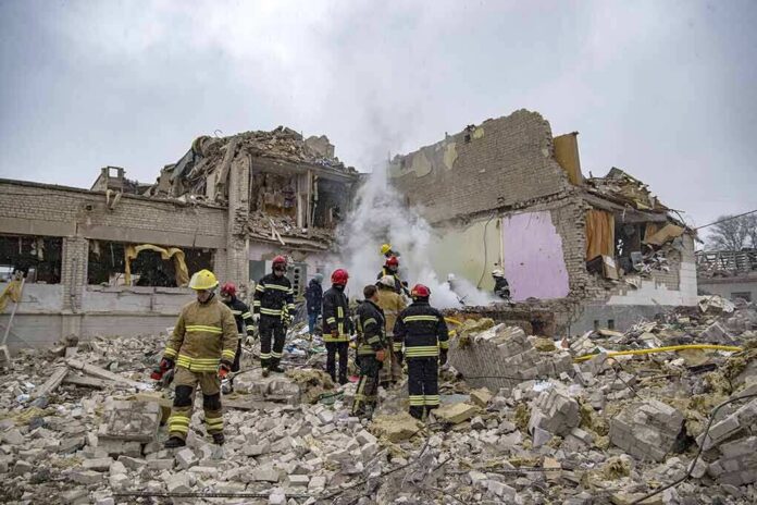 shutterstock_2132623665 Firefighters search rubble of a partially collapsed building
