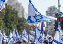 Knife-Edge Vote Freezes Israel Israeli flags waved at a street demonstration