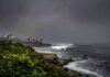Tourist Hotspot GONE – Deadly Cliffs Left Behind Rocky coastline with waves under dark storm clouds