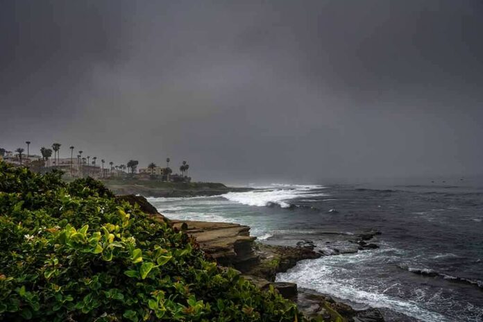Rocky coastline with waves under dark storm clouds