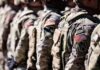 Soldiers in camouflage uniforms standing in formation