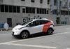 Autonomous test car with roof sensors on a city street