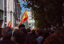 Snap Election After Housing Uproar Crowd with Spanish flags in a city street