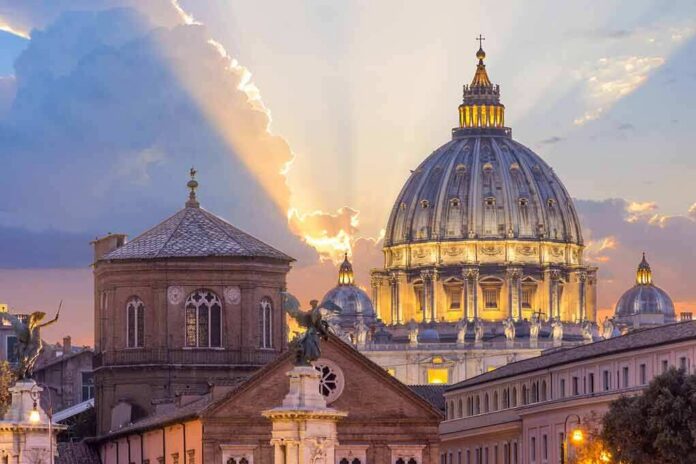 shutterstock_536262238 St. Peter's Basilica dome at sunset with glowing sky