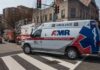 Ambulance and fire trucks at an urban intersection