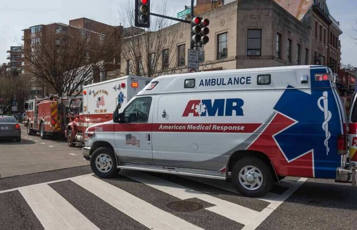 Ambulance and fire trucks at an urban intersection
