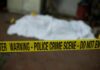 Warnings Mounted Before Two Toddlers Died crime scene tape in foreground with covered body in background