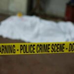 Warnings Mounted Before Two Toddlers Died crime scene tape in foreground with covered body in background