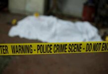 Warnings Mounted Before Two Toddlers Died crime scene tape in foreground with covered body in background