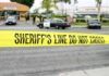 Bloody Robbery Stuns West Hollywood yellow sheriff's line tape blocks a street near police cars